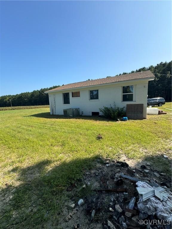 rear view of property with a yard