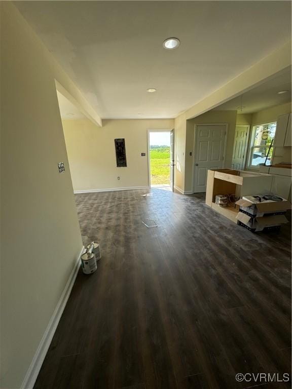 unfurnished living room with dark wood-type flooring