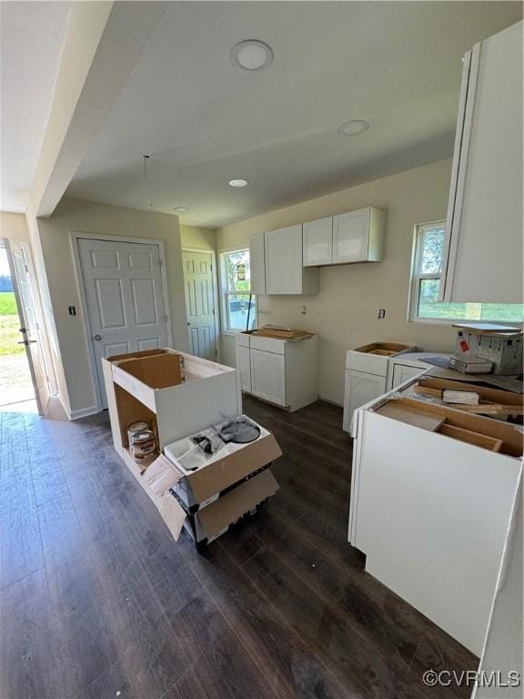 kitchen with white cabinets and dark wood-type flooring