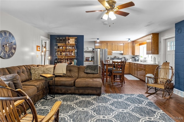 living room with ceiling fan and dark hardwood / wood-style floors