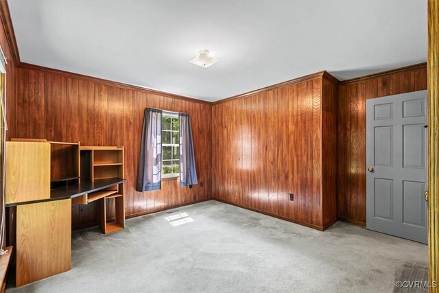 interior space featuring wooden walls, crown molding, and carpet floors