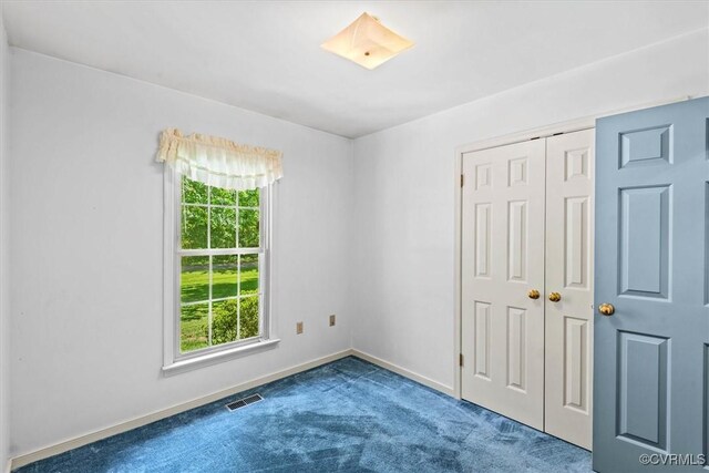 unfurnished bedroom with a closet and carpet