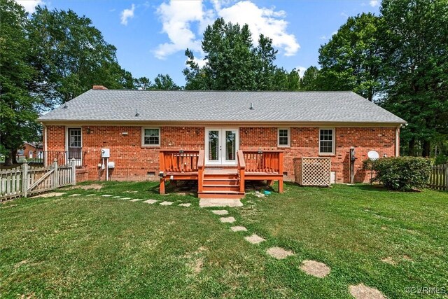 back of house featuring a wooden deck, a lawn, and french doors