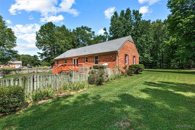 view of property exterior with a lawn and a deck