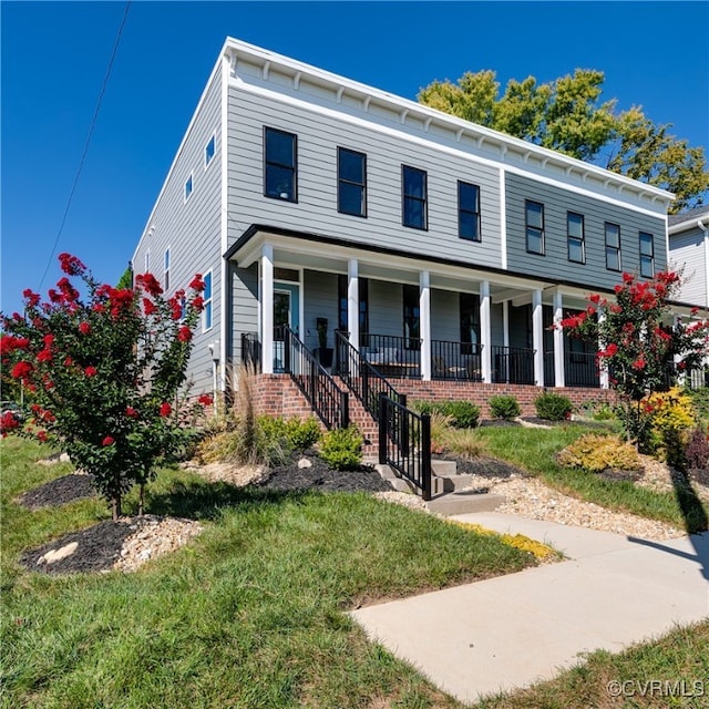 view of front of property with a front yard and covered porch