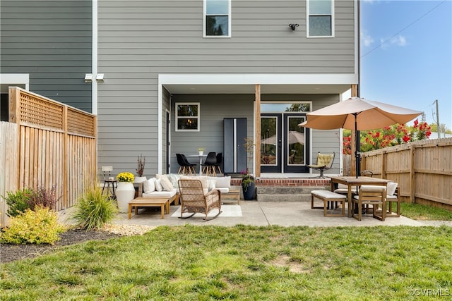 rear view of house with a yard, a patio, and an outdoor hangout area