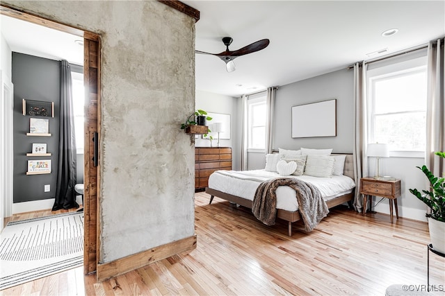 bedroom with ceiling fan and light hardwood / wood-style flooring