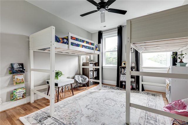 bedroom with ceiling fan and light wood-type flooring