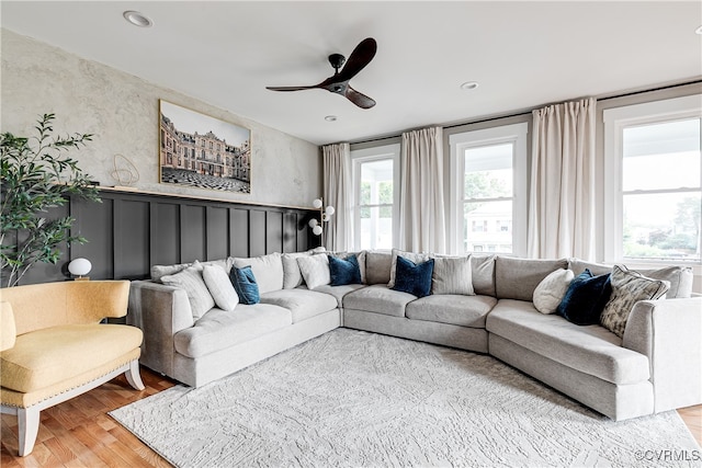 living room featuring light wood-type flooring and ceiling fan