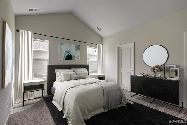 carpeted bedroom with multiple windows and vaulted ceiling