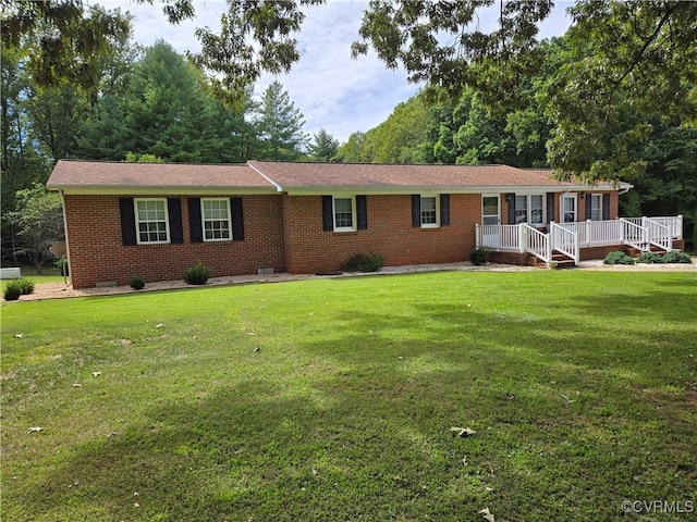 ranch-style home featuring a front yard and a deck