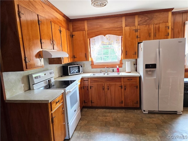 kitchen with white appliances, backsplash, and sink