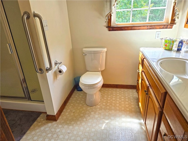 bathroom featuring a shower with shower door, toilet, and vanity