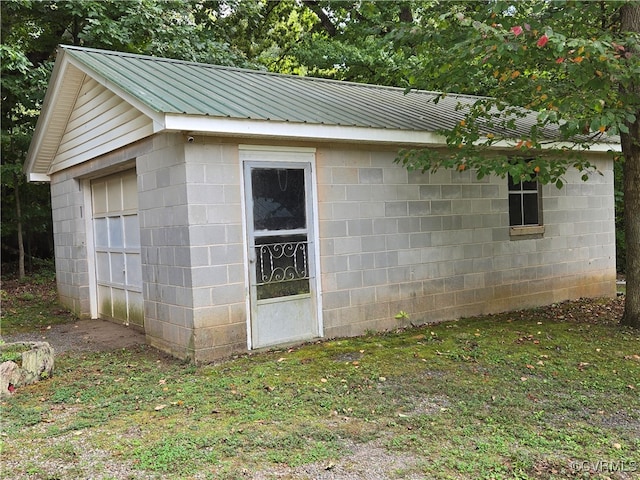 view of outbuilding featuring a yard and a garage