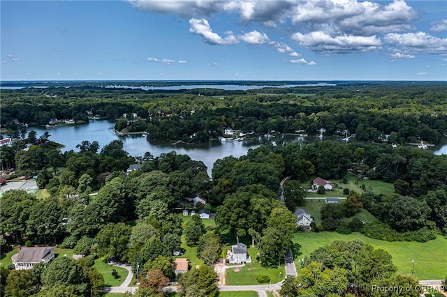 drone / aerial view with a water view and a wooded view