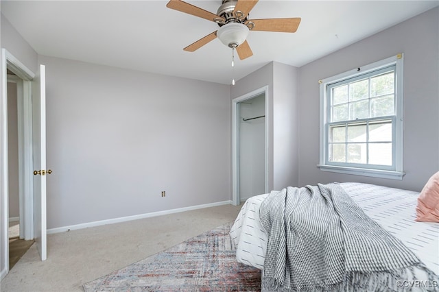 bedroom with a ceiling fan, baseboards, and light carpet