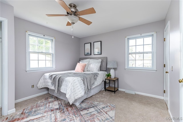 carpeted bedroom featuring baseboards and ceiling fan