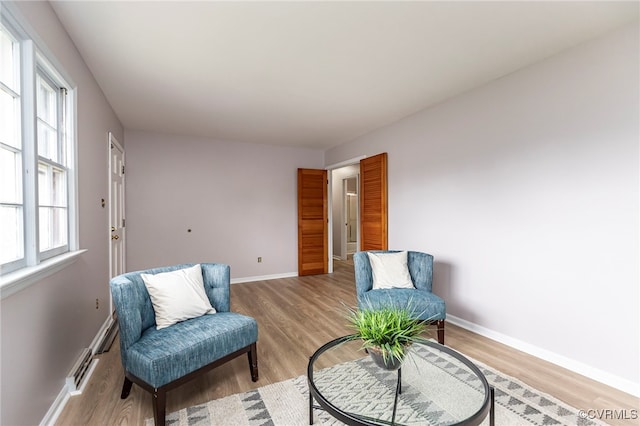 living area featuring baseboards and light wood-style floors