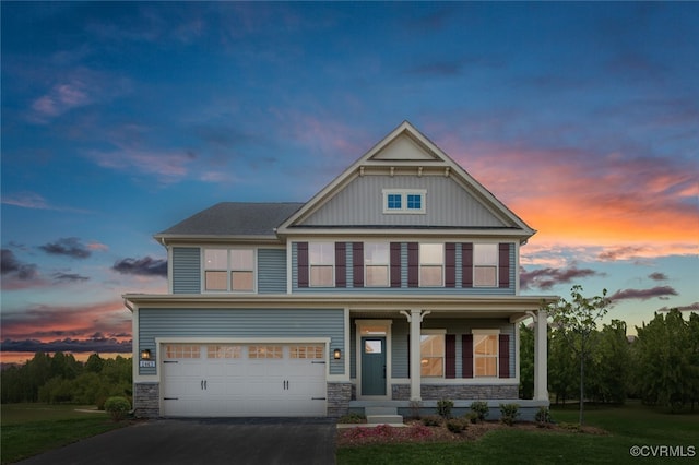 craftsman inspired home featuring a lawn, a garage, and a porch