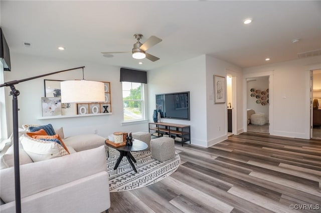 living area featuring visible vents, ceiling fan, baseboards, recessed lighting, and wood finished floors