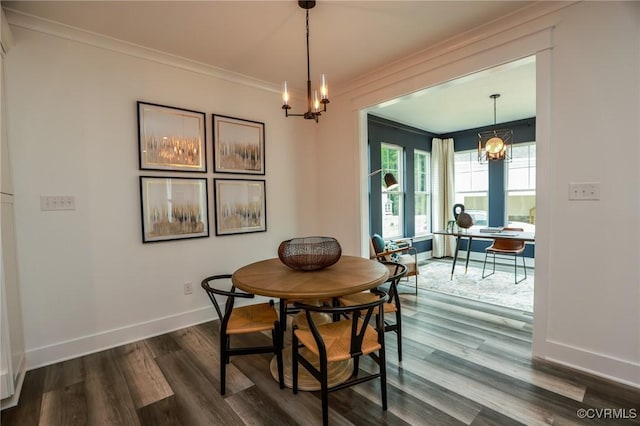 dining area featuring an inviting chandelier, crown molding, dark wood-type flooring, and baseboards