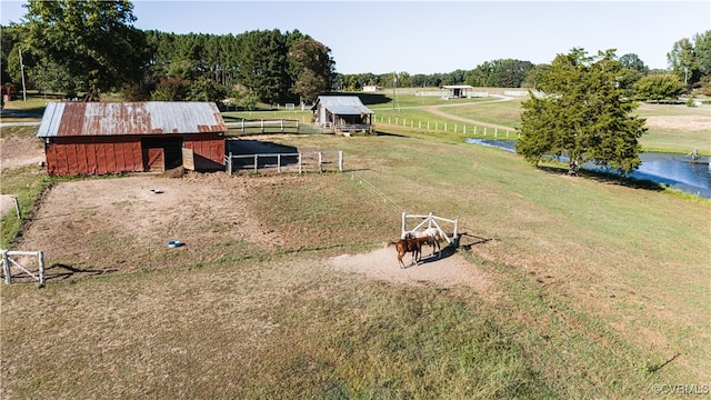 drone / aerial view featuring a water view and a rural view