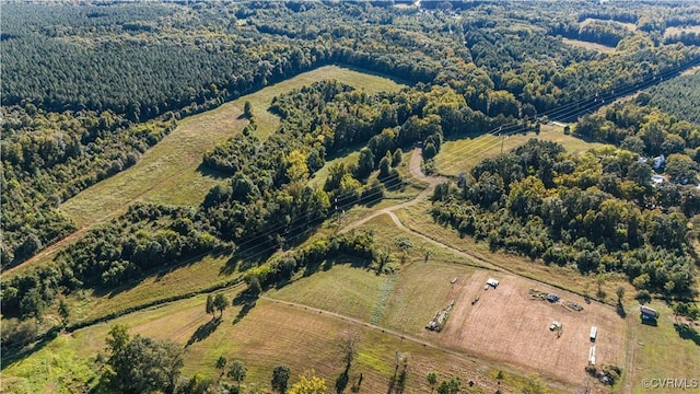 birds eye view of property with a view of trees