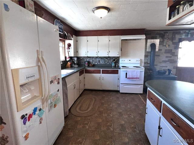 kitchen featuring white cabinets, white appliances, and decorative backsplash