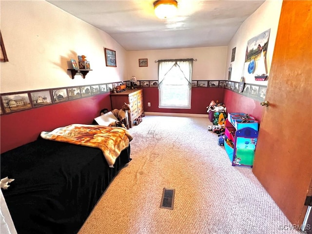 carpeted bedroom featuring visible vents