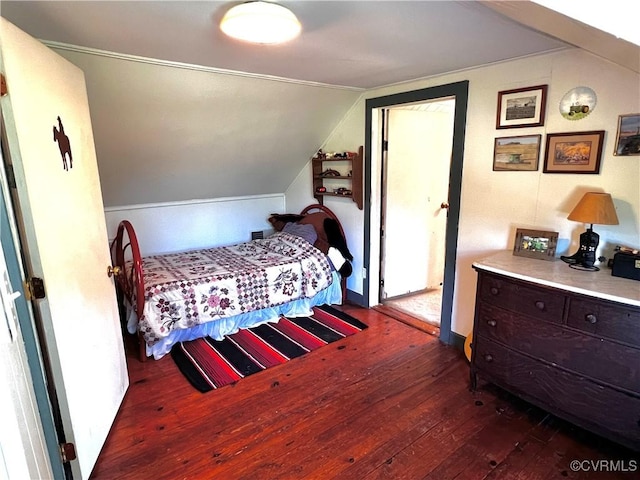 bedroom featuring vaulted ceiling and hardwood / wood-style flooring