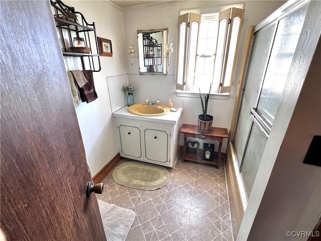 bathroom with tile patterned floors, an enclosed shower, and vanity