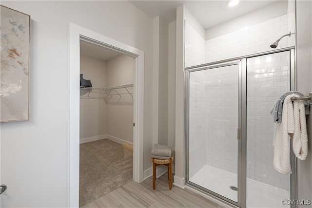 bathroom featuring hardwood / wood-style flooring and a shower with door