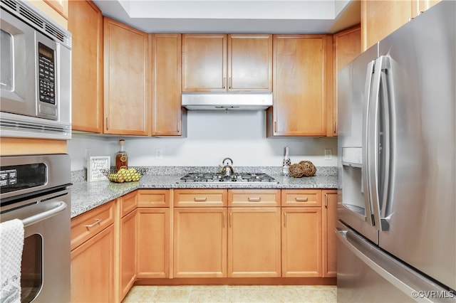 kitchen featuring light stone countertops and stainless steel appliances