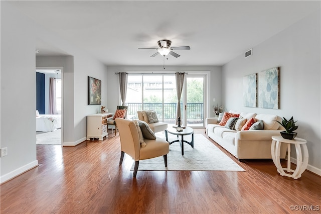 living room with ceiling fan and hardwood / wood-style floors