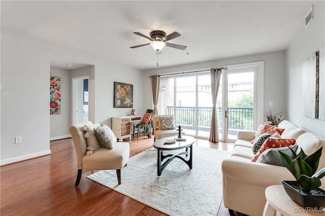 living room featuring ceiling fan and light hardwood / wood-style flooring