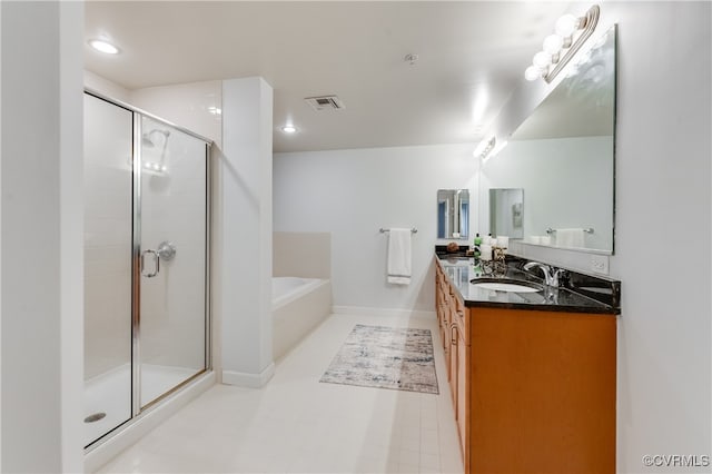 bathroom featuring shower with separate bathtub and vanity