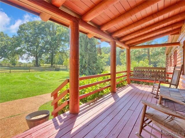 wooden terrace featuring a lawn