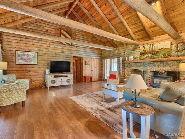 living room featuring wood ceiling, beamed ceiling, hardwood / wood-style flooring, high vaulted ceiling, and a stone fireplace