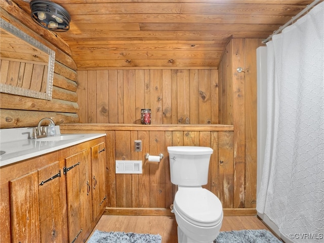 bathroom featuring vanity, wooden walls, vaulted ceiling, and wooden ceiling