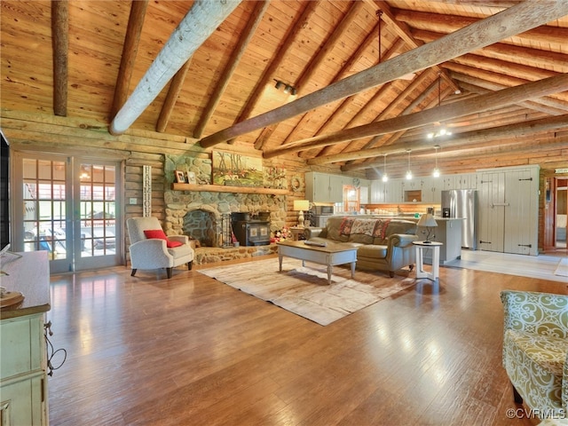 living room with beam ceiling, light hardwood / wood-style flooring, high vaulted ceiling, wooden ceiling, and a fireplace