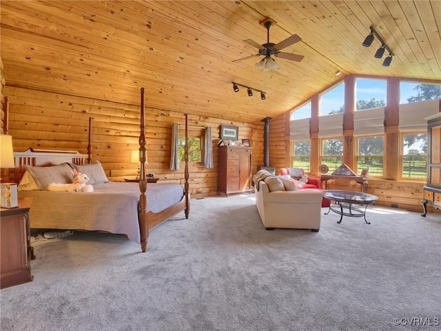 bedroom featuring light colored carpet, wooden ceiling, a wood stove, and rail lighting