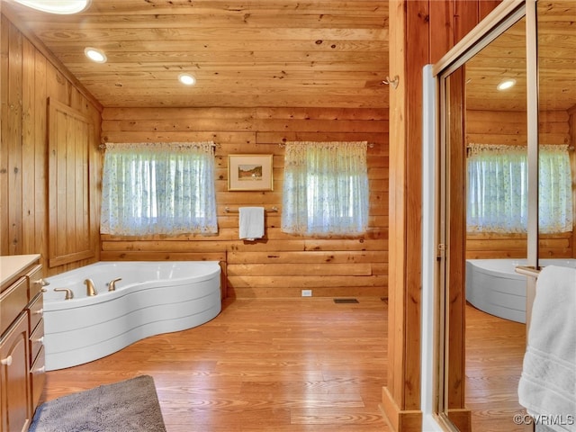 bathroom featuring wood-type flooring, wood ceiling, vanity, and a wealth of natural light