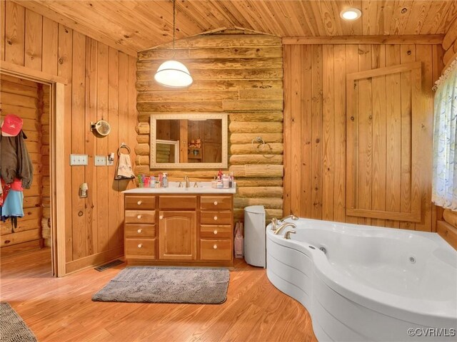 bathroom featuring vaulted ceiling, vanity, wooden ceiling, a bath, and hardwood / wood-style floors