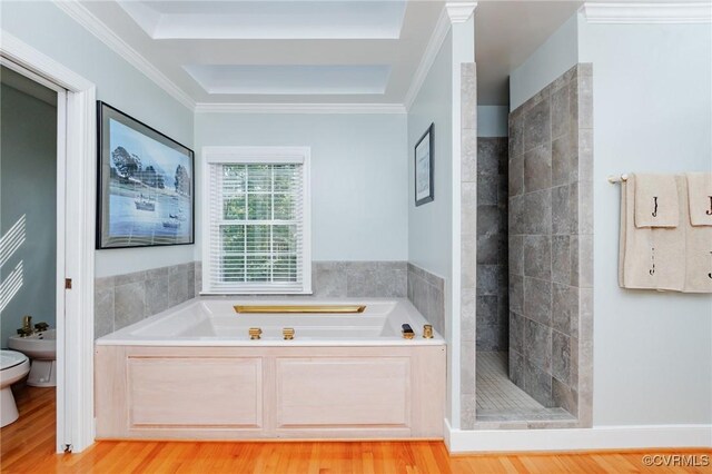 bathroom featuring a raised ceiling, crown molding, toilet, hardwood / wood-style flooring, and independent shower and bath