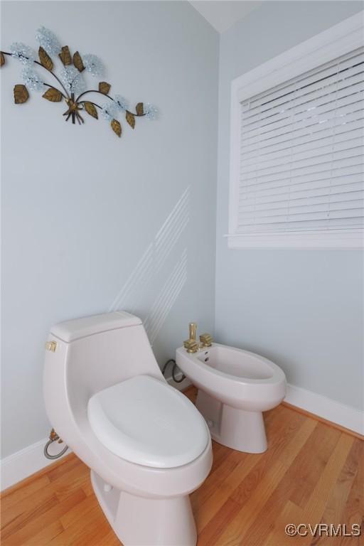 bathroom featuring a bidet, toilet, and wood-type flooring