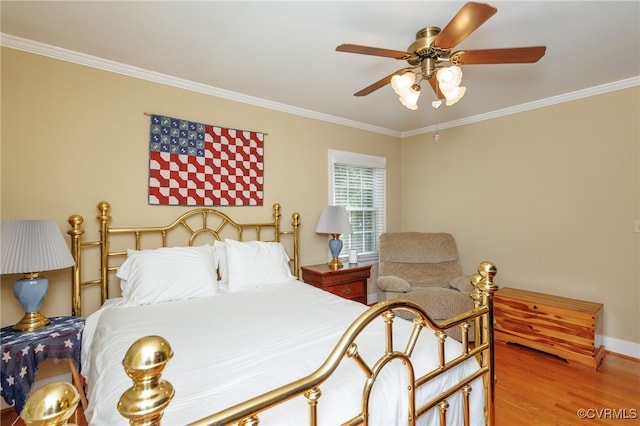 bedroom featuring ceiling fan, ornamental molding, and hardwood / wood-style floors