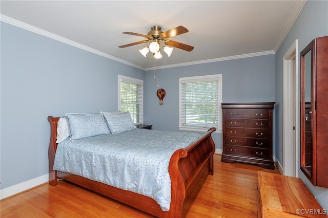 bedroom with light wood-type flooring, ceiling fan, and ornamental molding