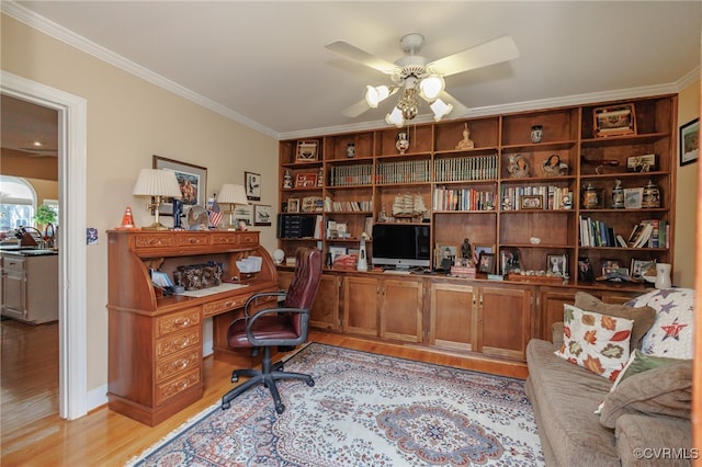 office featuring light wood-type flooring, ornamental molding, sink, and ceiling fan