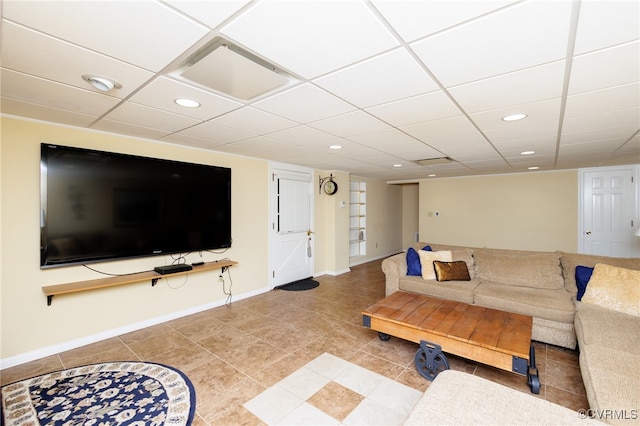 living room featuring a paneled ceiling and tile patterned flooring