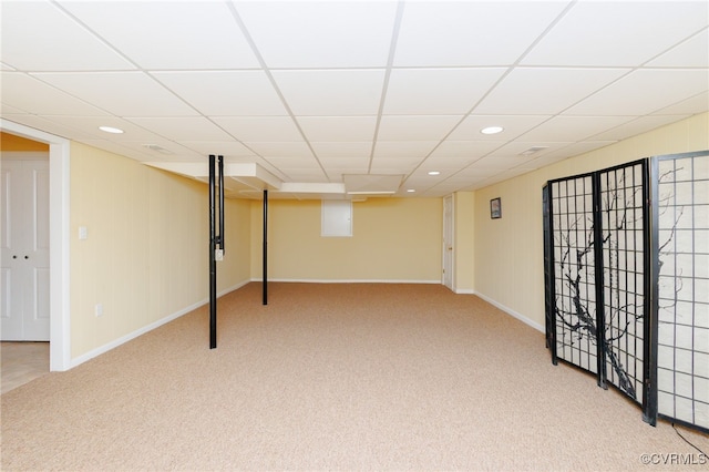 basement featuring carpet floors and a drop ceiling